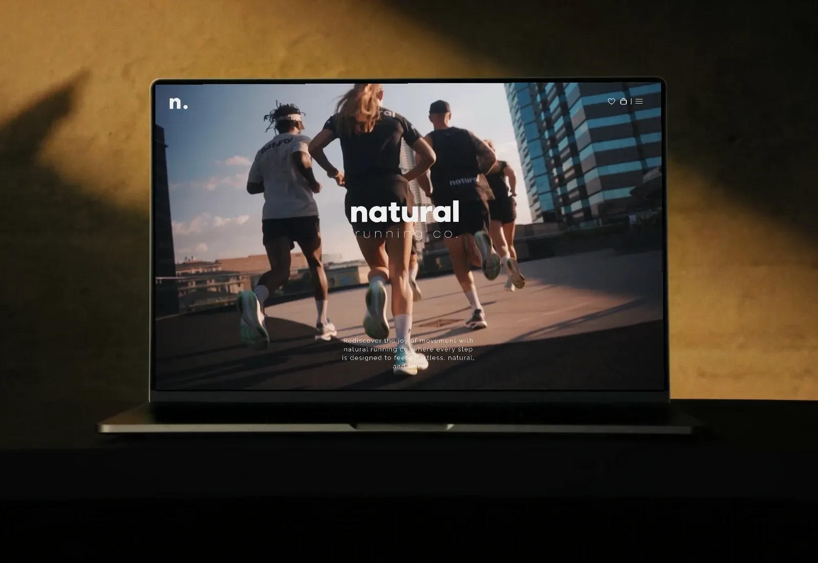 Natural Running Co Shopify store shown on a laptop — designed and developed by Shopify Lab